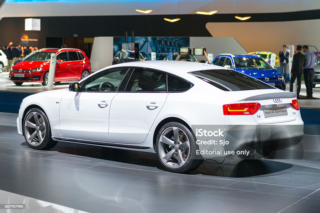 Audi A5 Sportback rear view Brussels, Belgium - Januari 12, 2016: White Audi A5 Sportback luxury hatchback coupe car rear view. The car is on display during the 2016 Brussels Motor Show. The car is displayed on a motor show stand, with lights reflecting off of the body. There are people looking around and other cars on display in the background. 2016 Stock Photo