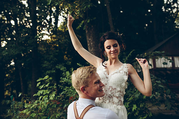 istock groom holds bride in his arms 507759772