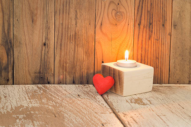 istock Red heart with scented candles put on old wooden table. 507760898