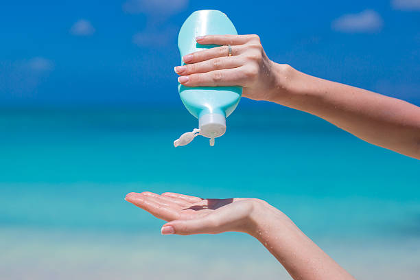 istock Woman hands putting sunscreen from a suncream bottle 507768045