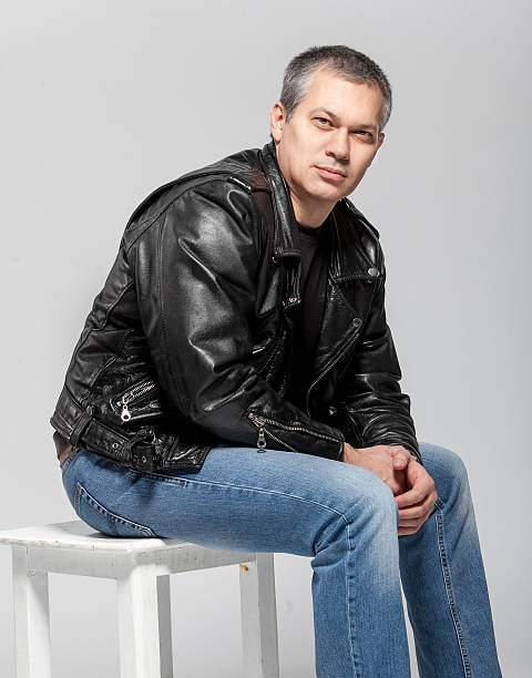 istock Man in leather jacket sitting on chair 507768491