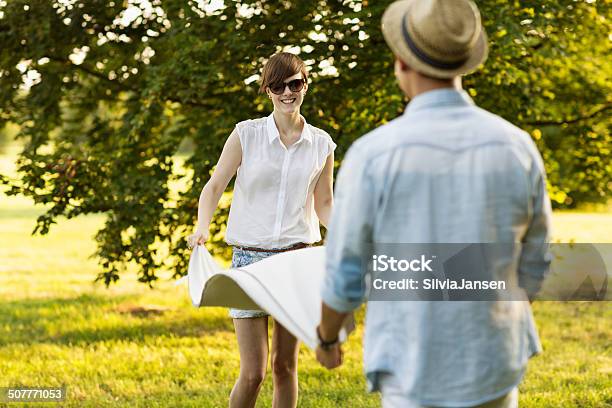 Young Man And Woman Folding Blanket Outdoors Summer Stock Photo - Download Image Now