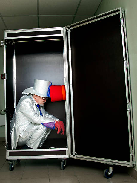 Magician sitting in a box Magician in a white suit with hat sitting in a box before the show pantomime dame stock pictures, royalty-free photos & images