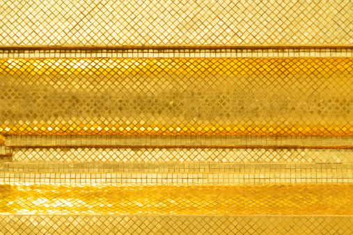 Golden wall at Wat Phra Kaew, Bangkok, Thailand..
