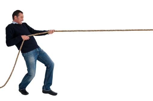man pulling a rope tug of war isolated white background