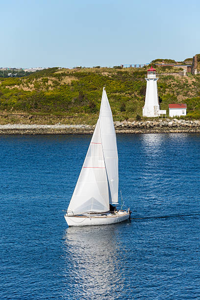 istock White Sailboat and Lighthouse with Blue water 507773789
