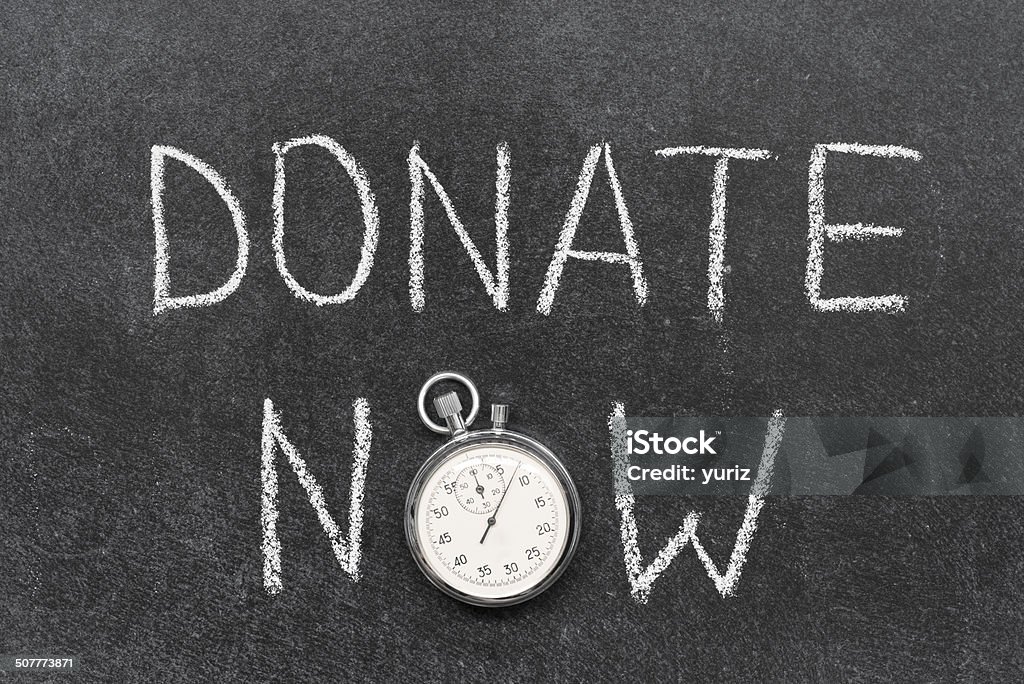 donate now donate now concept handwritten on chalkboard with vintage precise stopwatch used instead of O Accuracy Stock Photo