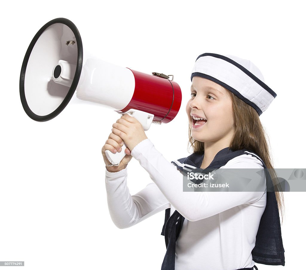 Sailor Girl with Megaphone Portrait of little girl dressed as a sailor screaming into megaphone. Studio shot, isolated on white. 6-7 Years Stock Photo