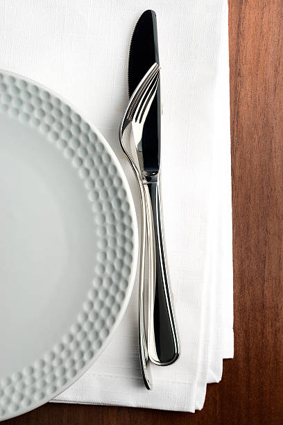 istock Knife and fork on white linnen napkin. 507774319
