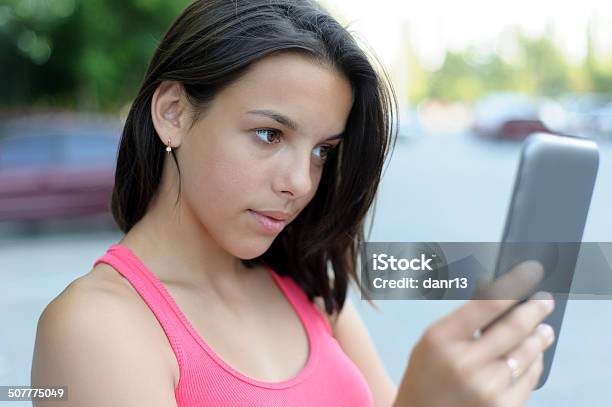 Girl Using Tablet Pc Outdoor Stock Photo - Download Image Now - Adult, Brown Hair, Communication