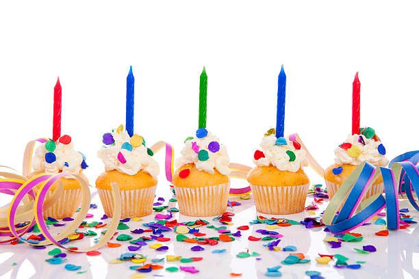 istock Birthday cupcakes with candle and colorful confetti 507787934