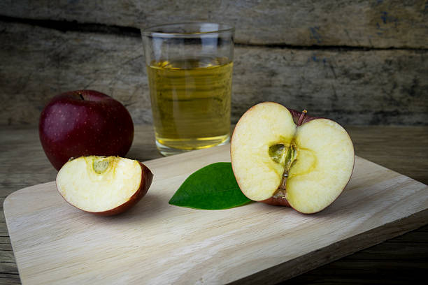 istock Apple juice and apples on a wooden table 507787988