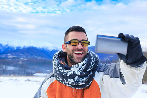 istock Young man taking selfie in snow mountain 507788244