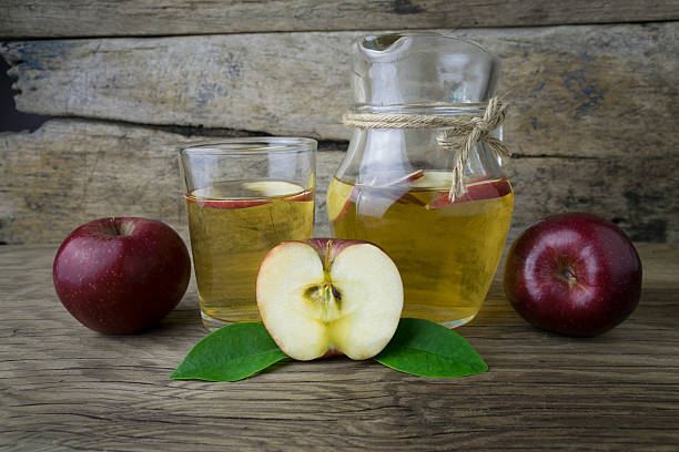 istock Apple juice and apples on a wooden table 507788758
