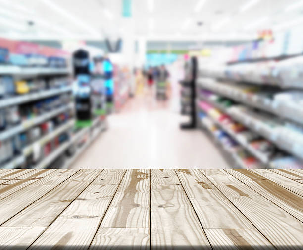istock Wood table and blurry Shopping store in background 507789668