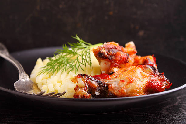 istock mashed potatoes with chicken wings on a black plate 507790114