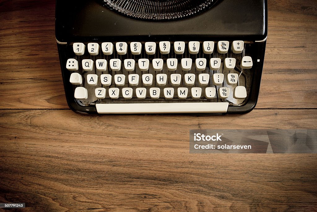 Vintage Typewriter A Vintage Typewriter on a wooden table. Horizontal Stock Photo