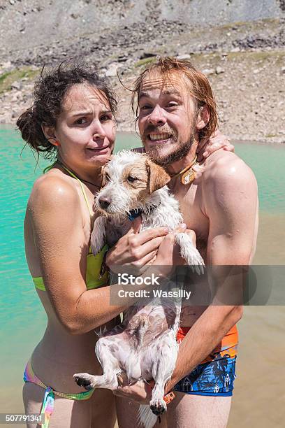 Happy Couple Swims In The Lake With A Small Dog Stock Photo - Download Image Now - Activity, Adult, Cheerful