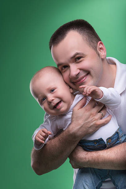istock Happy smiling father embracing his baby boy 507792041