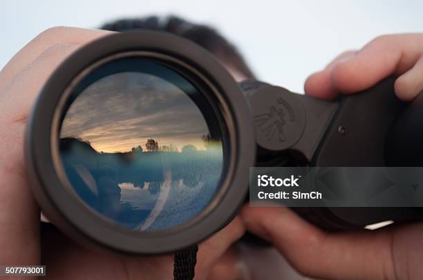 Man Looking Through Binoculars Stock Photo - Download Image Now - Binoculars, Looking Through Window, Looking