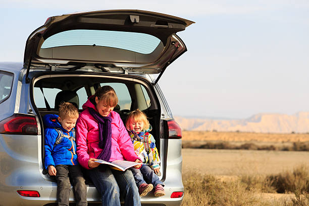 istock mother with kids looking at map while travel by car 507795108