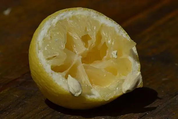 Part of lemon with seeds on the eating table, sour fruit, suitable form menus, decorative purposes etc.