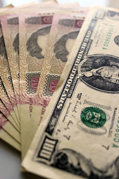 istock hundred dollars laying on the Ukrainian grivnas 507798097