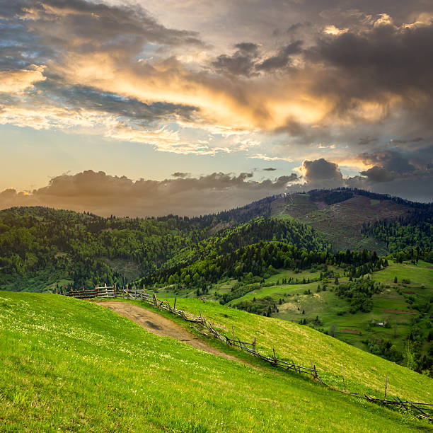 istock fence on hillside meadow in mountain at sunrise 507798275