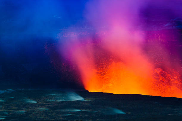 Erupting volcano Closeup shot of volcanic eruption at night with small steaming vents on Big Island, Hawaii pele stock pictures, royalty-free photos & images