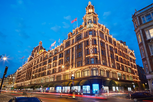 London, Uk - August 8, 2015: The famous Harrods department store illuminated in the evening Harrods is the biggest department store in Europe.