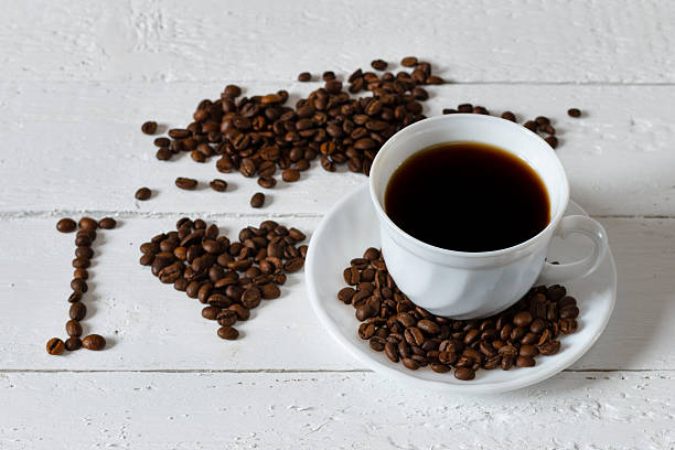 istock Coffee cup and saucer on a white wooden table 507804350