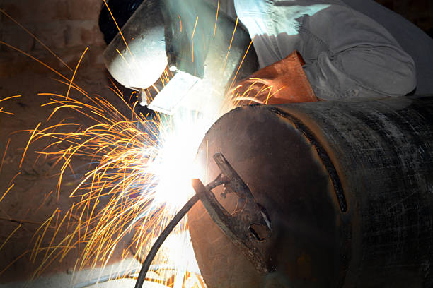 istock Men welding an industrial pipe closeup 507804458