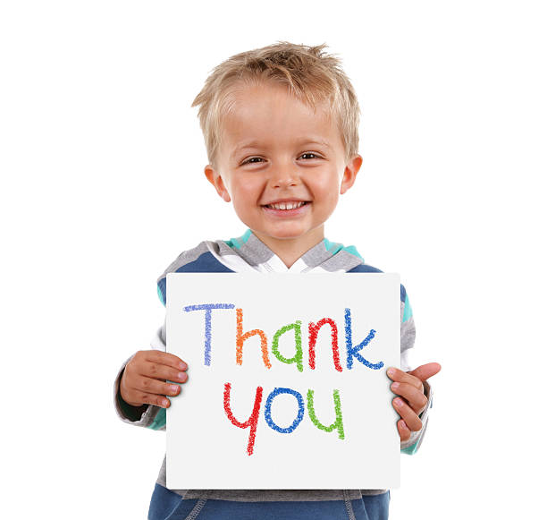 Thank you sign Child holding a crayon thank you sign standing against white background sayings stock pictures, royalty-free photos & images