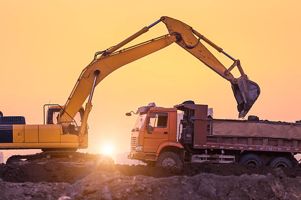 istock heavy wheel excavator machine working at sunset 507817449