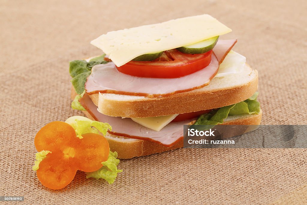 Sandwich Sandwich with rusks, vegetables, bacon and cheese on canvas background. Bacon Stock Photo