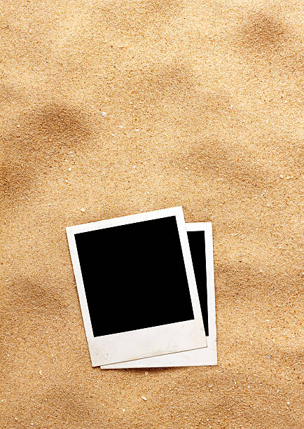 istock Old style empty photo cards lying on a sea sand 507819437
