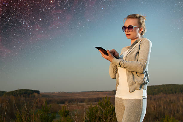 istock tablet a girl under the stars. 507823043