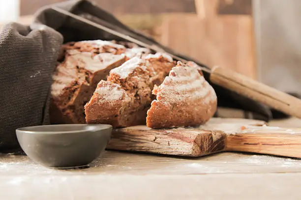Photo of Fresh bread and salt on a wooden background