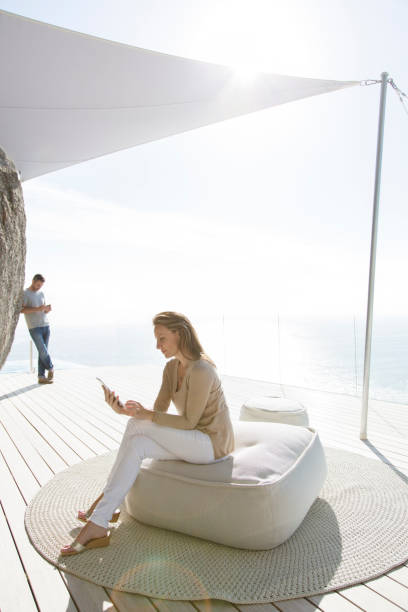 istock Woman using digital tablet on modern balcony 507831589