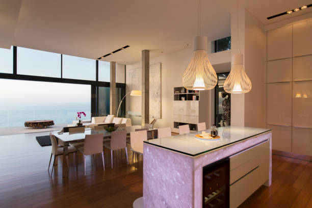 istock Modern kitchen and living area overlooking ocean 507831683