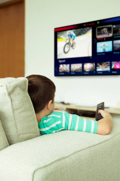 istock Boy watching television in living room 507831693