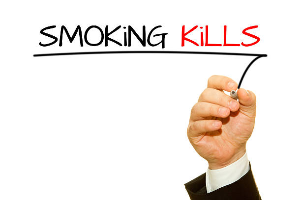 istock Human hand writing Smoking Kills isolated on white 507831904