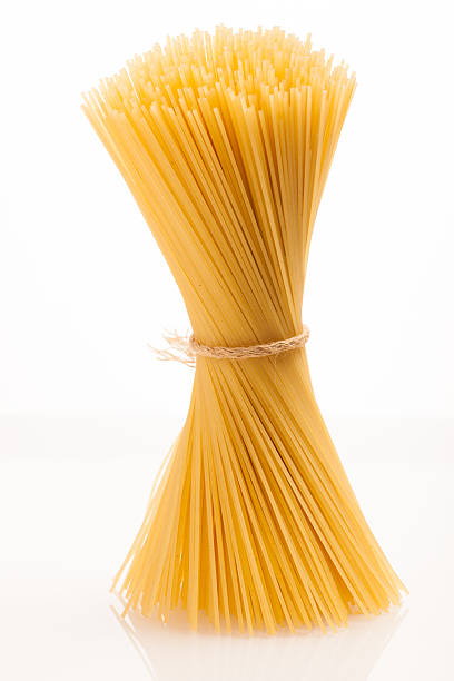 istock Wheat spaghetti standing tied with rope in bundle. 507831968