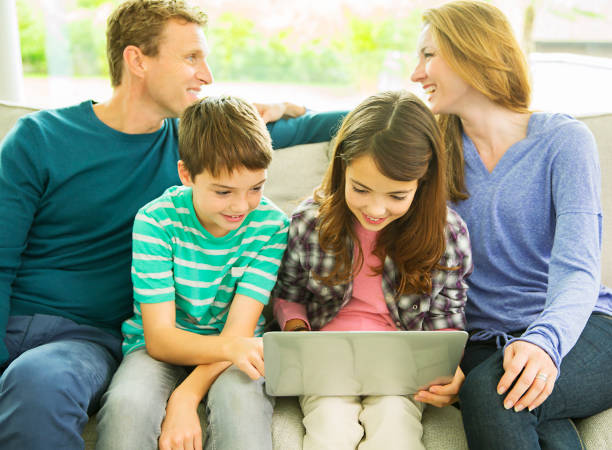 istock Family relaxing together on sofa 507832095