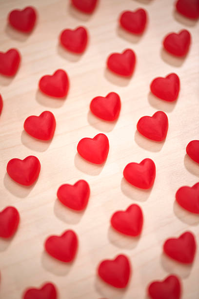 istock Rows of red heart shaped candies in formation 507832174