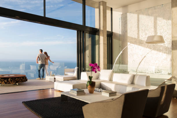 Couple standing on balcony of modern house wealthy house stock pictures, royalty-free photos & images