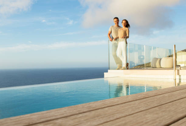 istock Couple on modern balcony overlooking ocean 507832841