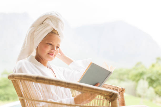istock Woman in bathrobe reading outdoors 507832869