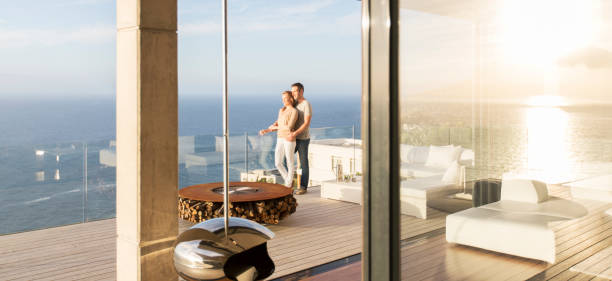 istock Couple on modern balcony overlooking ocean 507832925