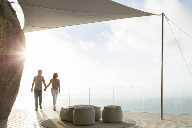 istock Couple holding hands on modern balcony 507833459